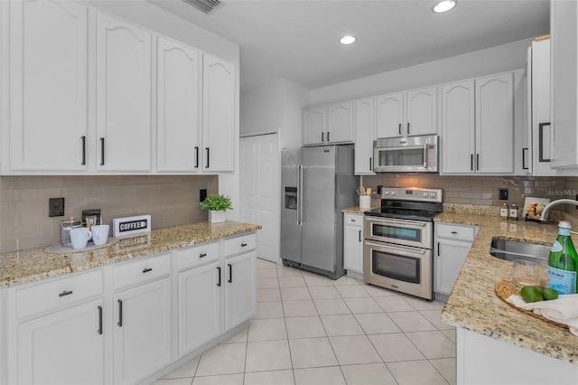 3002 Savannah Oaks Cir, Tarpon Springs, FL 34688 - kitchen with appliances with stainless steel finishes, a sink, light stone countertops, tasteful backsplash, and recessed lighting