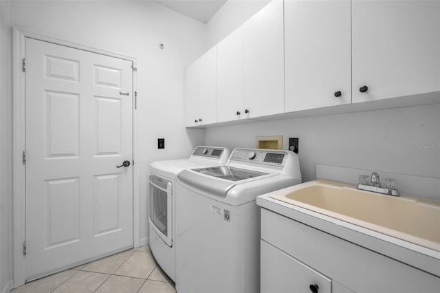 3002 Savannah Oaks Cir, Tarpon Springs, FL 34688 - clothes washing area with washer and clothes dryer, cabinet space, and light tile patterned floors