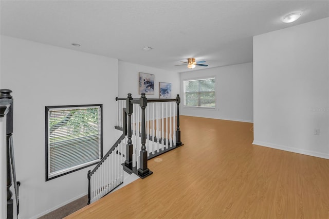 3002 Savannah Oaks Cir, Tarpon Springs, FL 34688 - hall featuring an upstairs landing, wood finished floors, and baseboards