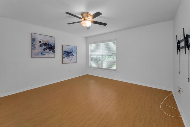 3002 Savannah Oaks Cir, Tarpon Springs, FL 34688 - empty room featuring a ceiling fan, wood finished floors, and baseboards