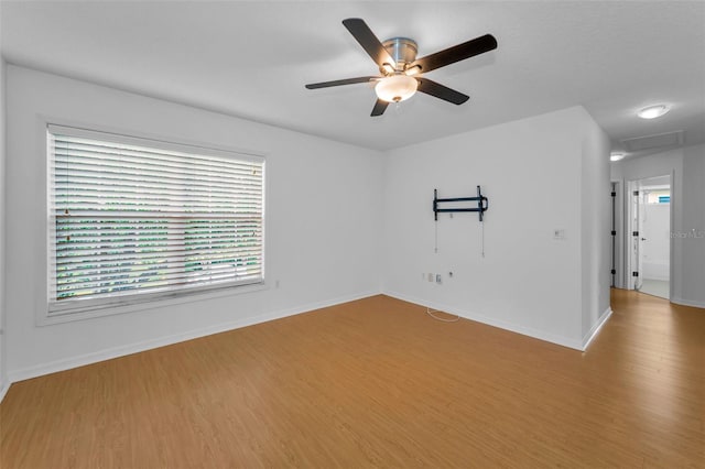 3002 Savannah Oaks Cir, Tarpon Springs, FL 34688 - empty room with wood finished floors, a ceiling fan, and baseboards