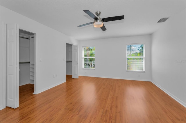 3002 Savannah Oaks Cir, Tarpon Springs, FL 34688 - unfurnished bedroom with light wood-type flooring, baseboards, and a ceiling fan
