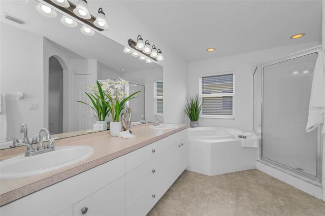 3002 Savannah Oaks Cir, Tarpon Springs, FL 34688 - bathroom with a shower stall, a garden tub, double vanity, recessed lighting, and tile patterned flooring