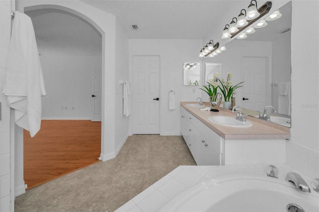 3002 Savannah Oaks Cir, Tarpon Springs, FL 34688 - bathroom with double vanity and baseboards