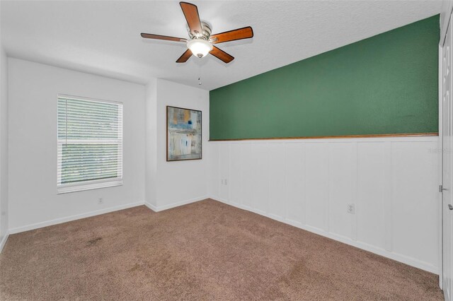 3002 Savannah Oaks Cir, Tarpon Springs, FL 34688 - carpeted empty room featuring ceiling fan and a wainscoted wall