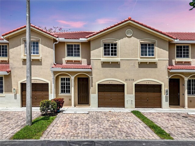 21115 NW 14th Pl Unit 2, Miami, FL 33169 - view of front of home with a tile roof, stucco siding, a garage, and driveway