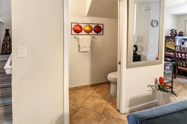 21115 NW 14th Pl Unit 2, Miami, FL 33169 - bathroom with tile patterned floors, toilet, baseboards, and a textured wall