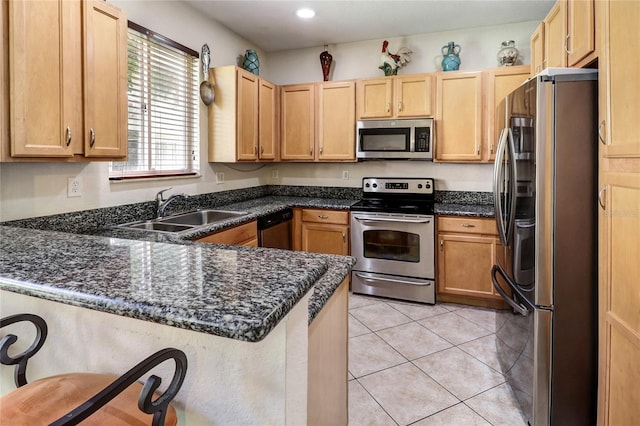 21115 NW 14th Pl Unit 2, Miami, FL 33169 - kitchen with stainless steel appliances, a sink, a peninsula, light brown cabinetry, and recessed lighting