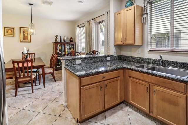 21115 NW 14th Pl Unit 2, Miami, FL 33169 - kitchen featuring a sink, a peninsula, light tile patterned flooring, and pendant lighting