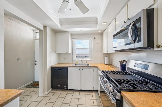 6020 S Shore Blvd Unit 709, Gulfport, FL 33707 - kitchen with stainless steel appliances, crown molding, decorative backsplash, a tray ceiling, and white cabinetry