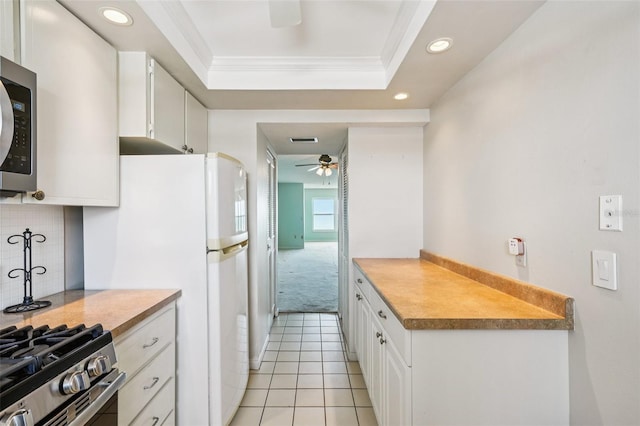 6020 S Shore Blvd Unit 709, Gulfport, FL 33707 - kitchen featuring stainless steel microwave, ceiling fan, ornamental molding, recessed lighting, and white cabinetry
