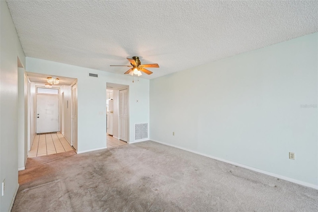 6020 S Shore Blvd Unit 709, Gulfport, FL 33707 - unfurnished bedroom with light colored carpet, a textured ceiling, and ceiling fan