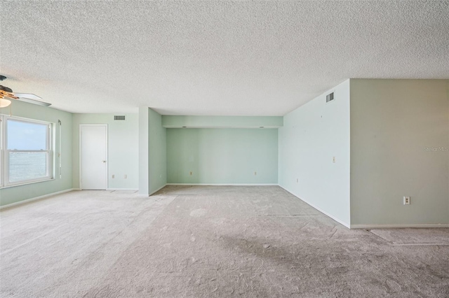 6020 S Shore Blvd Unit 709, Gulfport, FL 33707 - spare room featuring a ceiling fan, carpet, and a textured ceiling