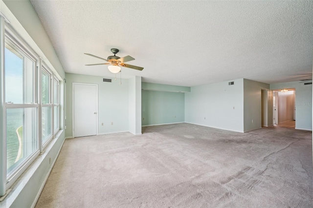 6020 S Shore Blvd Unit 709, Gulfport, FL 33707 - unfurnished room with a textured ceiling, a ceiling fan, and light carpet