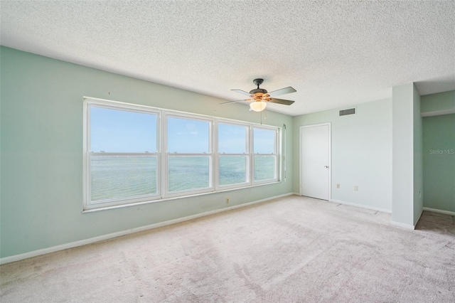 6020 S Shore Blvd Unit 709, Gulfport, FL 33707 - unfurnished bedroom with carpet, a textured ceiling, and ceiling fan