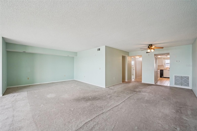 6020 S Shore Blvd Unit 709, Gulfport, FL 33707 - unfurnished living room with a textured ceiling, light carpet, and ceiling fan