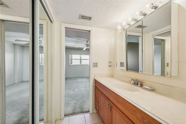 6020 S Shore Blvd Unit 709, Gulfport, FL 33707 - bathroom with a textured ceiling, vanity, a ceiling fan, and tile patterned floors