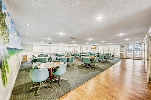 6020 S Shore Blvd Unit 709, Gulfport, FL 33707 - dining room featuring wood finished floors, a textured ceiling, french doors, and recessed lighting