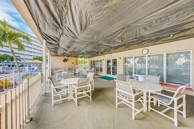 6020 S Shore Blvd Unit 709, Gulfport, FL 33707 - view of patio featuring outdoor dining area and french doors