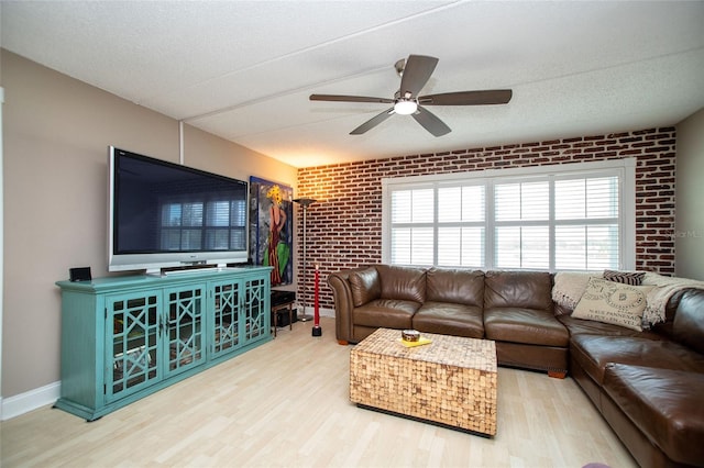12300 Park Blvd Unit 222, Seminole, FL 33772 - living room featuring brick wall, wood finished floors, and ceiling fan