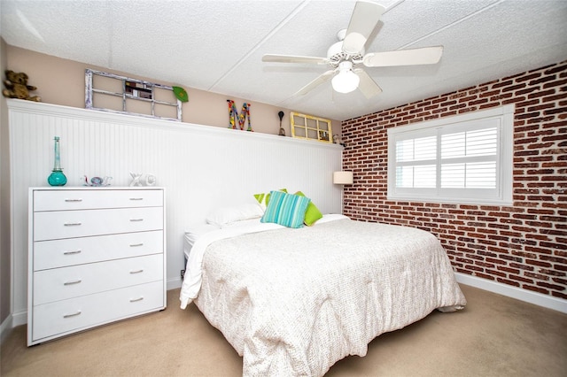 12300 Park Blvd Unit 222, Seminole, FL 33772 - carpeted bedroom with brick wall, a ceiling fan, a textured ceiling, wainscoting, and baseboards
