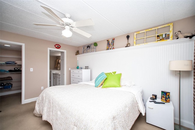 12300 Park Blvd Unit 222, Seminole, FL 33772 - carpeted bedroom with a spacious closet, a closet, connected bathroom, and ceiling fan