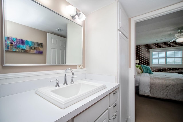 12300 Park Blvd Unit 222, Seminole, FL 33772 - bathroom featuring connected bathroom, a ceiling fan, vanity, and wainscoting