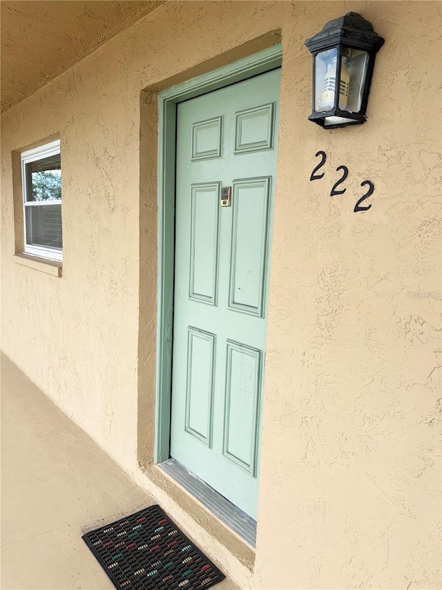 12300 Park Blvd Unit 222, Seminole, FL 33772 - view of exterior entry with stucco siding