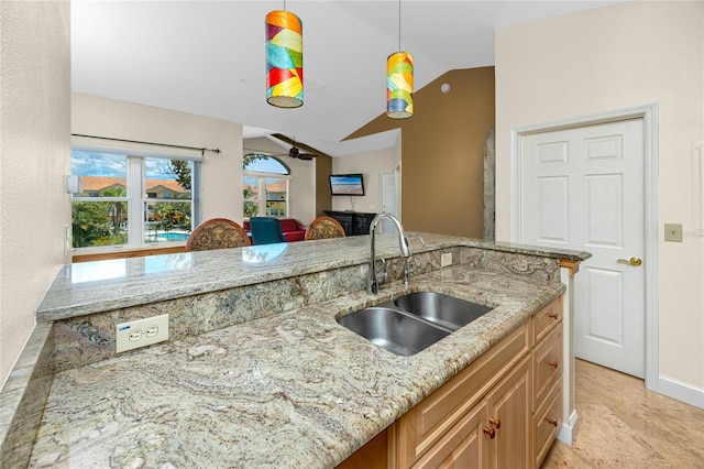 10764 70th Ave Unit 5302, Seminole, FL 33772 - kitchen with a sink, lofted ceiling, light stone countertops, hanging light fixtures, and a ceiling fan