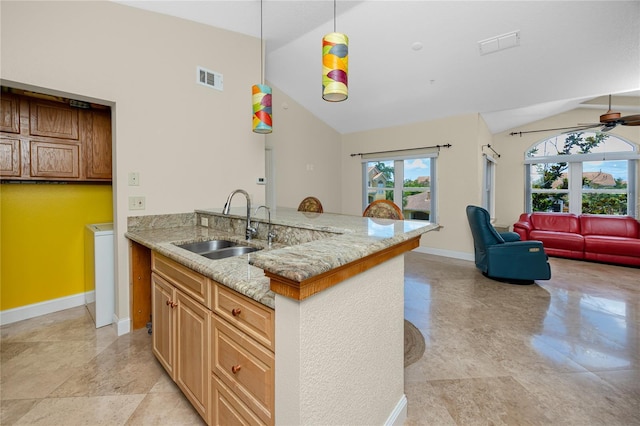 10764 70th Ave Unit 5302, Seminole, FL 33772 - kitchen with a sink, baseboards, ceiling fan, light stone counters, and open floor plan