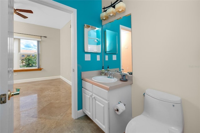 10764 70th Ave Unit 5302, Seminole, FL 33772 - bathroom with vanity, toilet, ceiling fan, and baseboards