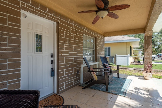 314 Bath St, Tarpon Springs, FL 34689 - doorway to property with brick siding, a porch, and a ceiling fan