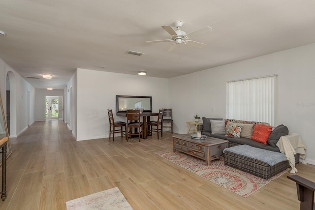 314 Bath St, Tarpon Springs, FL 34689 - living room featuring light wood-style floors, ceiling fan, and baseboards