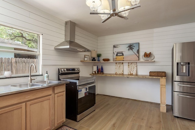 314 Bath St, Tarpon Springs, FL 34689 - kitchen featuring appliances with stainless steel finishes, island exhaust hood, a sink, wood walls, and light wood-style flooring