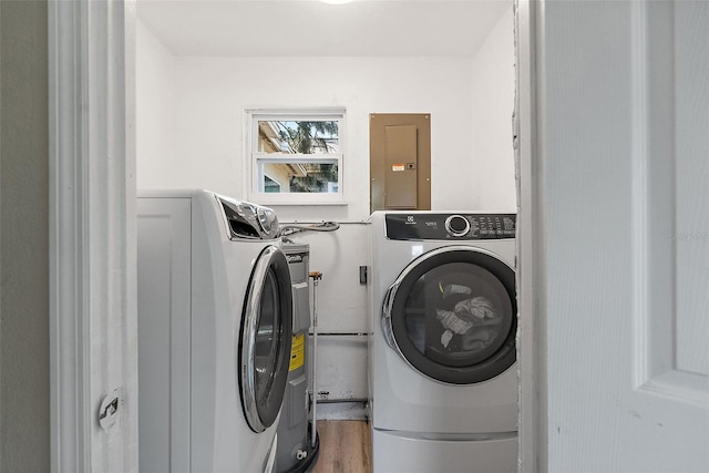 1310 43rd St S, Saint Petersburg, FL 33711 - washroom featuring electric panel, independent washer and dryer, and wood finished floors