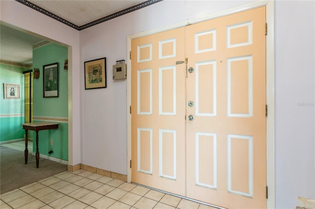 7317 W Pocahontas Ave, Tampa, FL 33634 - foyer with crown molding, baseboards, light tile patterned floors, and light carpet