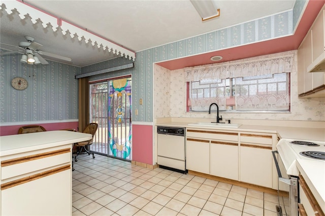 7317 W Pocahontas Ave, Tampa, FL 33634 - kitchen featuring a sink, white appliances, light countertops, wallpapered walls, and a ceiling fan