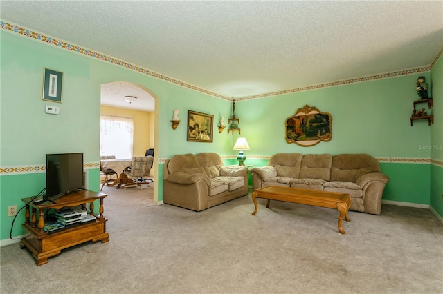 7317 W Pocahontas Ave, Tampa, FL 33634 - living area with a textured ceiling, arched walkways, and carpet flooring