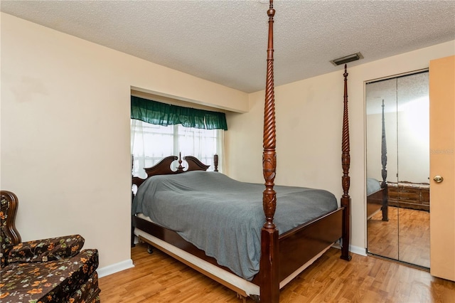 7317 W Pocahontas Ave, Tampa, FL 33634 - bedroom featuring wood finished floors and a textured ceiling