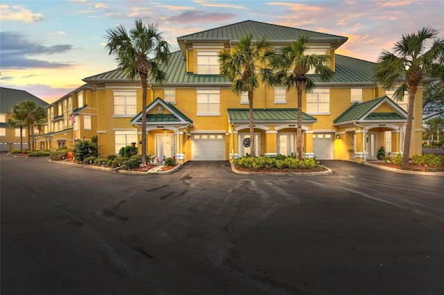 6319 Sunset Bay Cir, Apollo Beach, FL 33572 - multi unit property with a standing seam roof, metal roof, asphalt driveway, an attached garage, and stucco siding