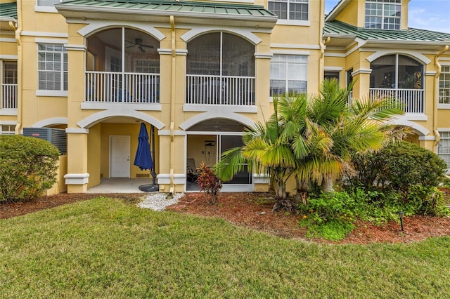 6319 Sunset Bay Cir, Apollo Beach, FL 33572 - back of house featuring stucco siding, a standing seam roof, and metal roof