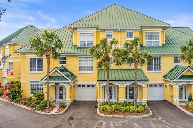 6319 Sunset Bay Cir, Apollo Beach, FL 33572 - view of front of home with a standing seam roof, metal roof, stucco siding, and driveway
