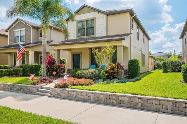 4264 Bexley Village Dr, Land O Lakes, FL 34638 - view of front of house with stucco siding, a front yard, and a porch