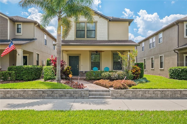 4264 Bexley Village Dr, Land O Lakes, FL 34638 - view of front of house with covered porch, stucco siding, and a front lawn