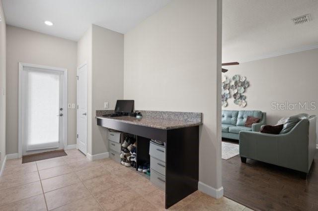 4264 Bexley Village Dr, Land O Lakes, FL 34638 - office with baseboards, light tile patterned floors, and ceiling fan