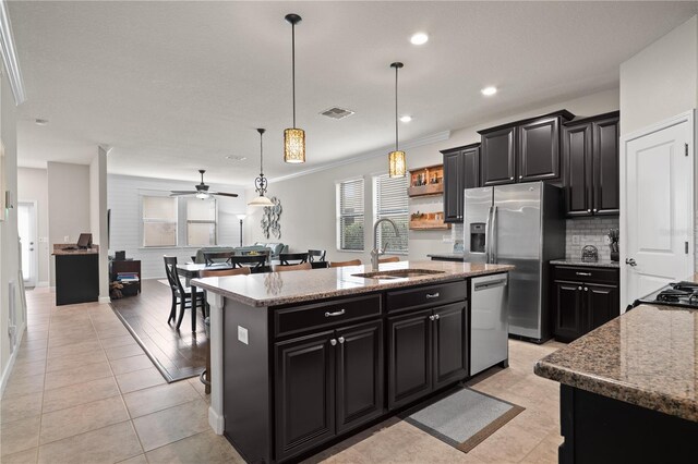 4264 Bexley Village Dr, Land O Lakes, FL 34638 - kitchen with a sink, dark cabinets, appliances with stainless steel finishes, a center island with sink, and recessed lighting