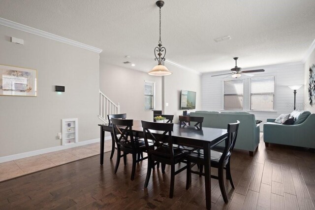 4264 Bexley Village Dr, Land O Lakes, FL 34638 - dining room featuring crown molding, a ceiling fan, a textured ceiling, stairway, and wood finished floors