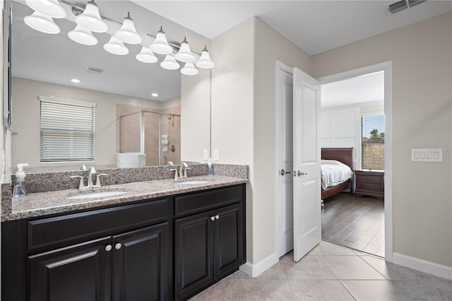 4264 Bexley Village Dr, Land O Lakes, FL 34638 - ensuite bathroom with a shower stall, double vanity, baseboards, and tile patterned flooring