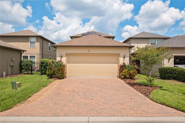 4264 Bexley Village Dr, Land O Lakes, FL 34638 - view of front of home featuring decorative driveway, a garage, stucco siding, and roof with shingles