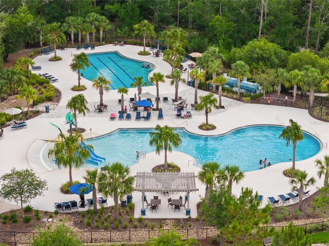 4264 Bexley Village Dr, Land O Lakes, FL 34638 - community pool featuring a pergola, a patio area, and view of scattered trees